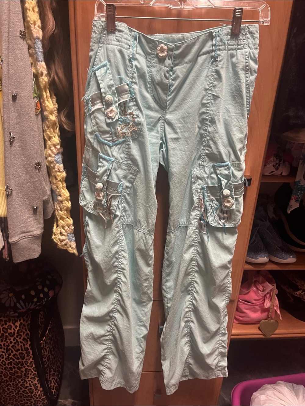 Soft light blue designer pants with lots of details.